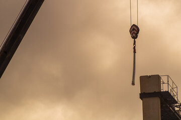 The lifting hooks of the construction crane are brought to the object at a height. Concept of...