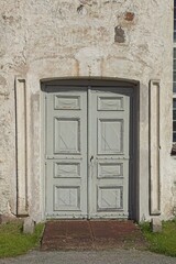 Wooden double door on a stone building.