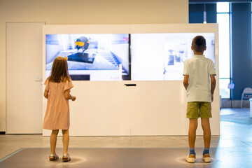 Children learn interactively by looking at monitors and performing certain movements, visiting a science museum