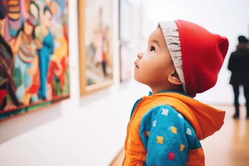 Poster child looking curiously at a bright, pop-art piece in a museum © Natalia
