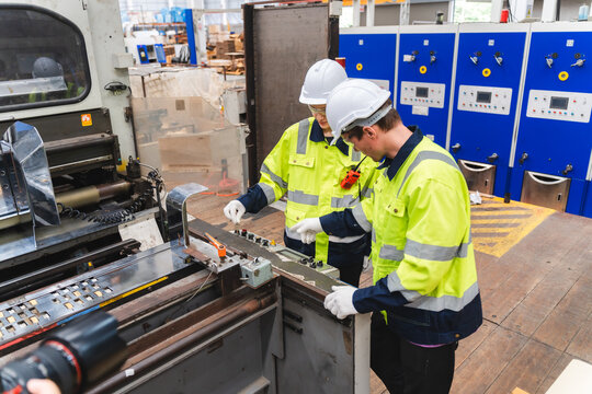 paper cardboard manufacture factory concept, industry worker person working with machine to recycling material package box in warehouse storage or plant production for global logistic business