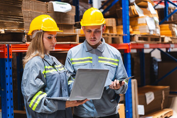 Factory manager, foreman worker checking stock inventory on good shelf in delivery storehouse of...