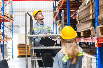 Professional worker team in safety uniform, supervisor inspector in packaging stock order at cardboard factory warehouse, piles of stacking paper manufacture, recycling industrial production