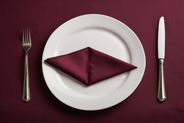 plate with cutlery and burgundy napkin