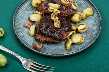 Grilled ostrich steak with kiwi berries