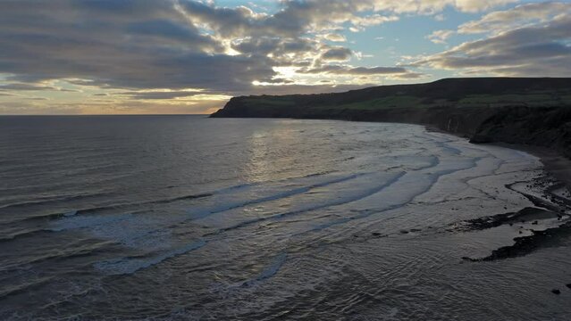 Establishing Drone Shot of Yorkshire East Coast Beach and Cliffs Sunrise