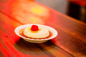 Kiwi cream pudding, Panna Cotta with kiwi sauce, on a plate. Light gray background 