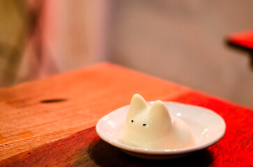 Kiwi cream pudding, Panna Cotta with kiwi sauce, on a plate. Light gray background 