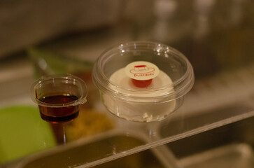 Kiwi cream pudding, Panna Cotta with kiwi sauce, on a plate. Light gray background 