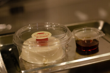 Kiwi cream pudding, Panna Cotta with kiwi sauce, on a plate. Light gray background 