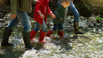 Young family with two little daughters on mountain trek