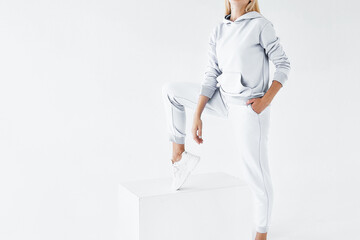Back view of a young woman wearing white minimalist sweatpants. Step into Comfort with a Chic White...