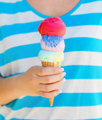 Close up of ice cream cone in woman hand