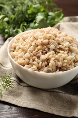Delicious pearl barley in bowl on table, closeup