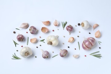 Fresh garlic, rosemary and peppercorns on white background, flat lay