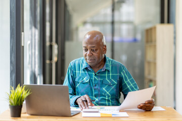 Business senior man 60 years old using laptop computer in office. Happy middle aged man, entrepreneur, small business owner working online.