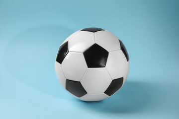 Naklejka premium One soccer ball on light blue background. Sports equipment