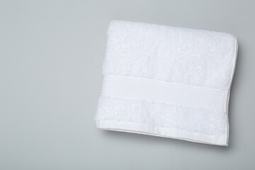 White terry towel on light grey background, top view. Space for text