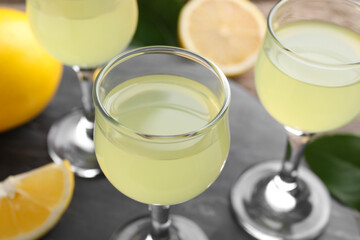 Tasty limoncello liqueur on table, closeup view