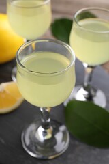 Tasty limoncello liqueur on table, closeup view
