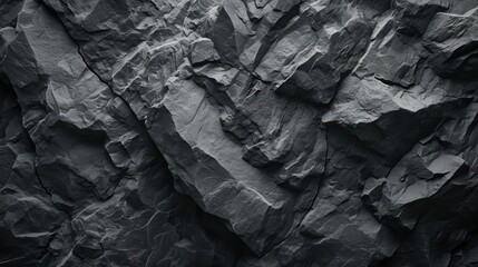 Dark grey, cracked mountain surface forming a textured black stone background. A spacious canvas for design purposes.
