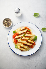 Grilled halloumi cheese with couscous and vegetables