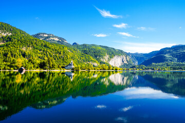 View of the Grundlsee and the surrounding landscape. Idyllic nature by the lake in Styria in Austria. Mountain lake at the Totes Gebirge in the Salzkammergut.
