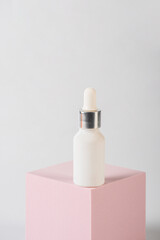 Plastic white tube for cream or lotion. Skin care or sunscreen cosmetic with stylish props on white background 