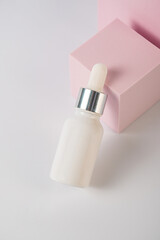 Plastic white tube for cream or lotion. Skin care or sunscreen cosmetic with stylish props on white background 