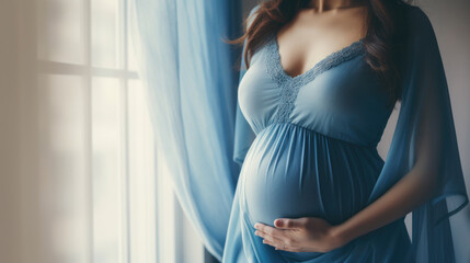 Young beautiful sexy and stylish pregnant woman in blue - blue background.