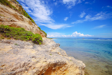 rocky coast of the sea with blue sky and blue sea background