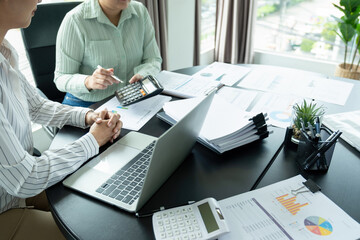 Businesswomen working together at desk.
