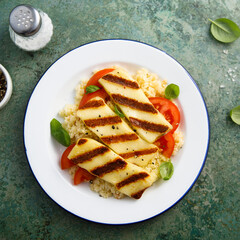 Grilled halloumi cheese with couscous and vegetables