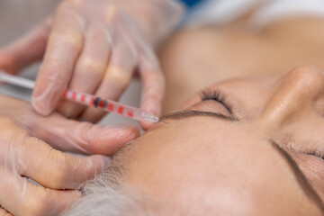 Woman having beauty procedures at beauty clinic and receiving beauty injections
