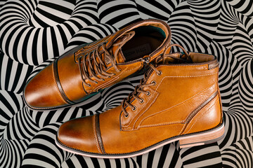 A pair of premium calfskin boots on a black and white background. Horizontal shot.