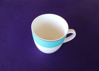 Antique Porcelain Empty Tea Cup isolated on blue background