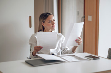 Cute blonde young wo,an working with documents