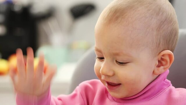 A little caucasian boy, one year old, sneezes and snot comes out of his nose. Colds and viruses in children. Flu and infections, close-up