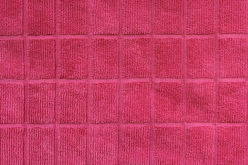 Close up textured background of pink square pattern fabric