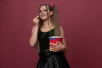 Portrait of impressed lady hand hold popcorn isolated on red color background