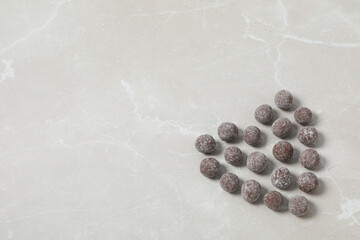A heart made of sweet candies on a light background.
