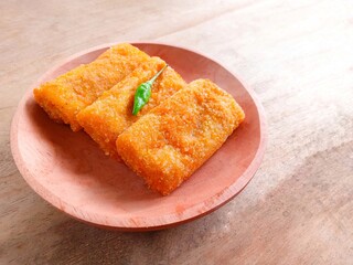 Risol snack filled with shredded chicken and vegetables in wooden plate on wood background. fried snacks. traditional savory and delicious snack, risoles. tea time.