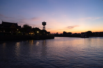 sunset over the river with Waterfront Traditional Thai House