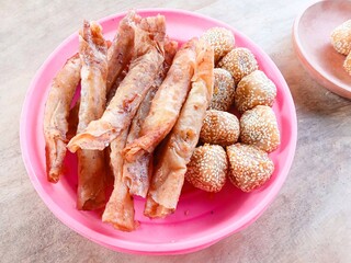 onde-onde, fried bread filled with green beans then smeared with sesame and piscok or chocolate banana wrapped in spring roll skin. traditional Indonesian snacks. fried snack for tea time.