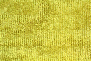 Close up textured background of yellow cloth fabric