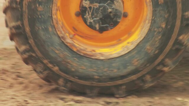 The wheel and tire of the tractor leaves a mark on the fresh sand. Off-road protector, close-up