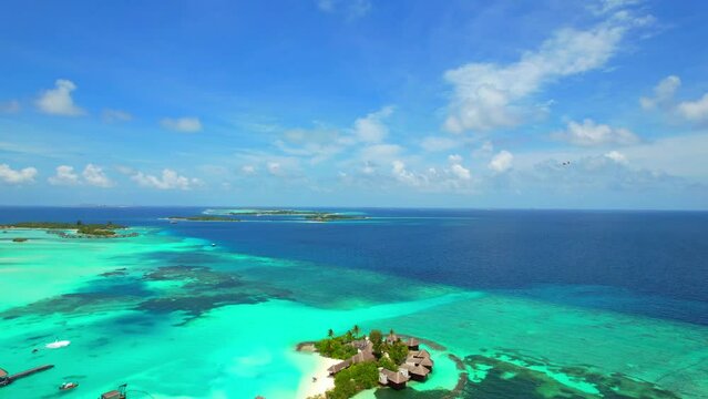 Huraa Island - Maldives - Still image aerial view over the island chain with seaplane flying past