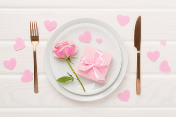 Festive table setting for Valentine's Day on wooden background, top view