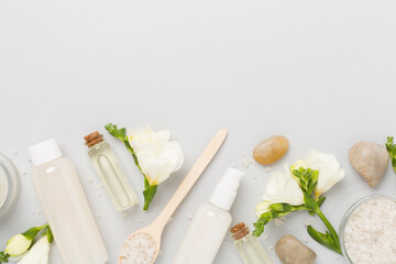 Flat lay with spa products and flowers on color background