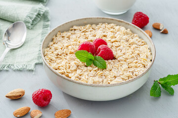 Bowl of porridge or oatmeal with fruits close up. Breakfast concept.